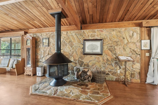 interior details featuring a wood stove, hardwood / wood-style floors, wooden ceiling, and beam ceiling