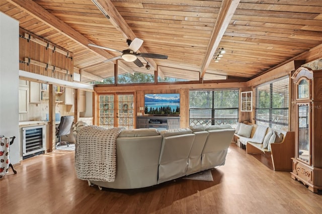 living room with wine cooler, wood ceiling, light hardwood / wood-style flooring, and lofted ceiling with beams