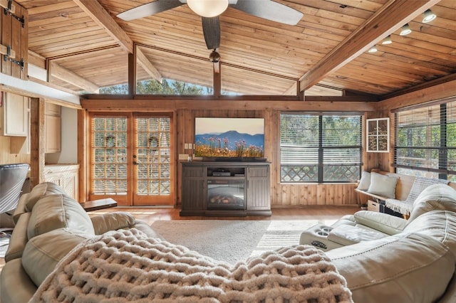 living room with vaulted ceiling with beams, hardwood / wood-style floors, wood ceiling, and wood walls