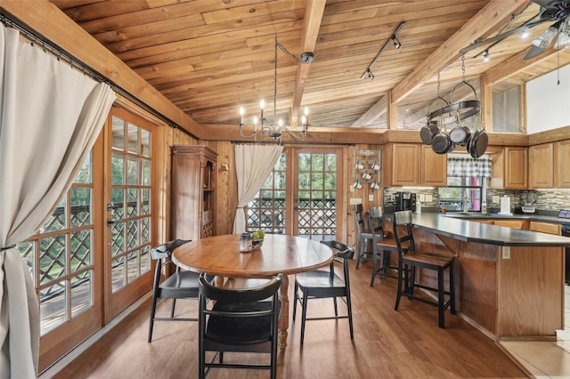 dining area with wood ceiling, plenty of natural light, hardwood / wood-style floors, and french doors