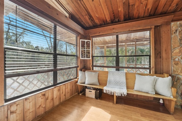 sunroom / solarium featuring wood ceiling and a wealth of natural light