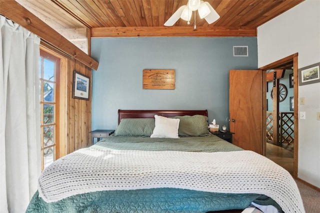 carpeted bedroom with wood ceiling and ceiling fan