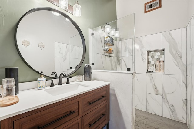 bathroom featuring vanity and a tile shower