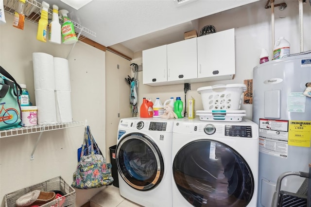 laundry room with independent washer and dryer, light tile patterned floors, cabinets, and electric water heater