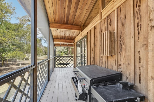 sunroom featuring wood ceiling and beamed ceiling