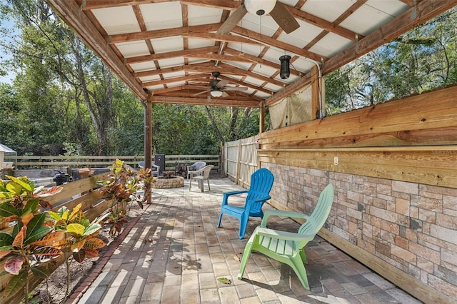 view of patio featuring ceiling fan and an outdoor fire pit