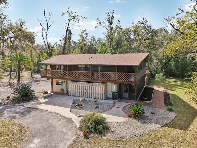 view of front of property with a garage and central air condition unit