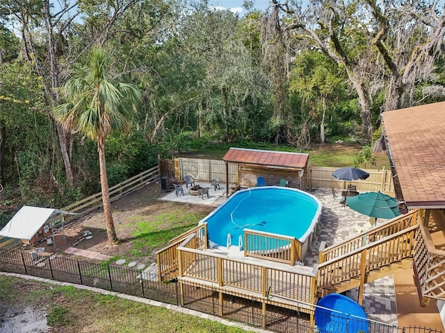 view of pool with a wooden deck and a patio area