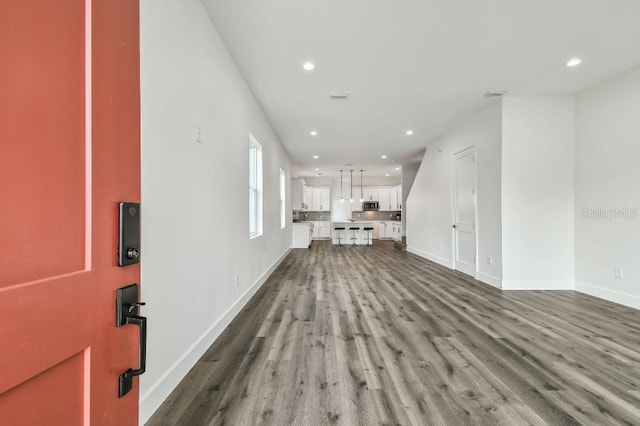 unfurnished living room featuring hardwood / wood-style flooring