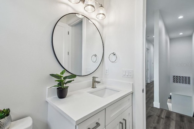 bathroom featuring vanity and hardwood / wood-style floors