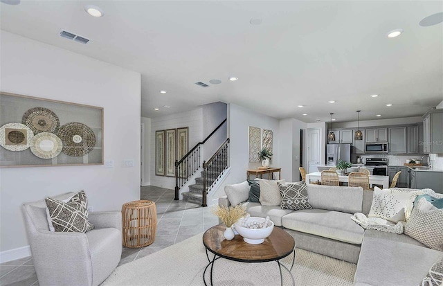 living room featuring light tile patterned flooring and sink