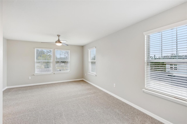 empty room with ceiling fan and carpet floors