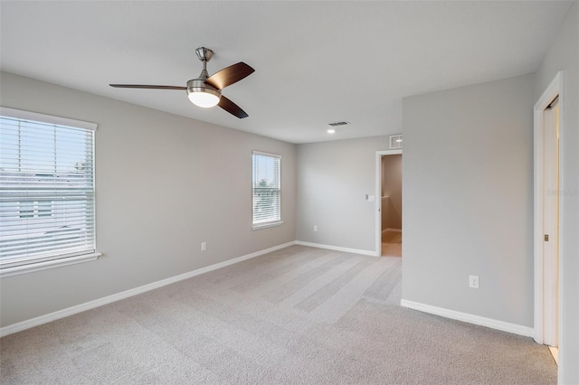 carpeted empty room featuring ceiling fan