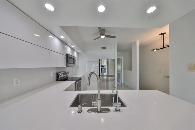 kitchen featuring sink, stainless steel appliances, white cabinetry, and ceiling fan