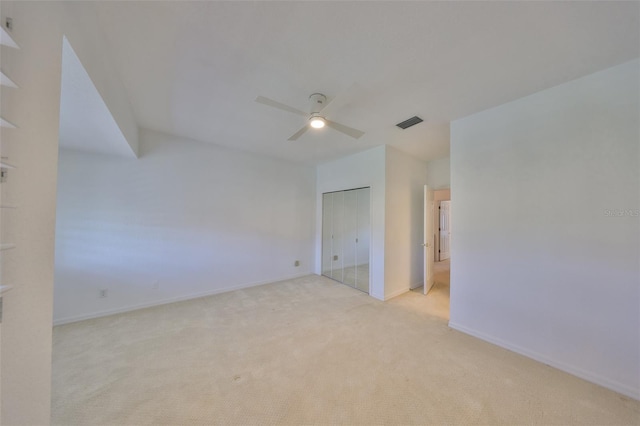 carpeted empty room featuring ceiling fan