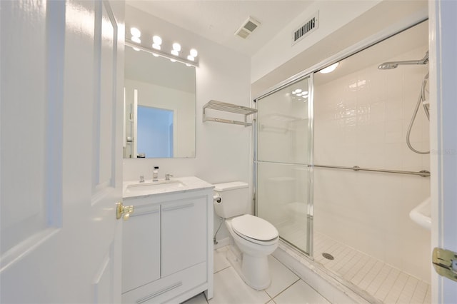 bathroom with toilet, tile patterned flooring, walk in shower, and vanity