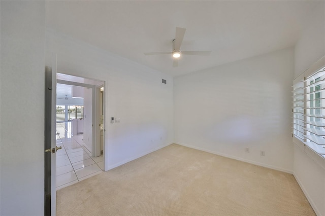 empty room with ceiling fan and light colored carpet