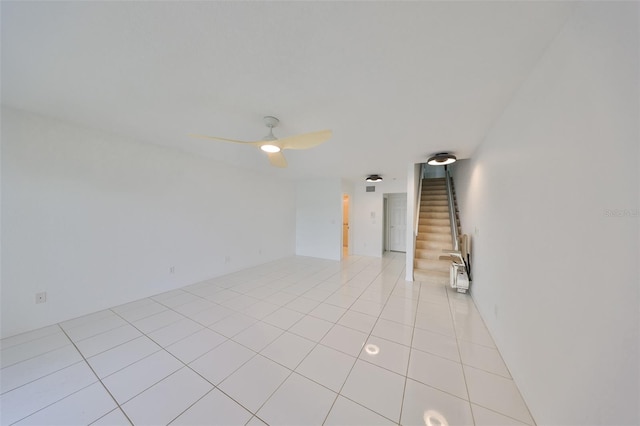 unfurnished room with ceiling fan and light tile patterned floors