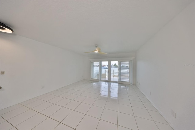 unfurnished room with light tile patterned floors and ceiling fan