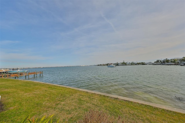 dock area featuring a water view and a yard