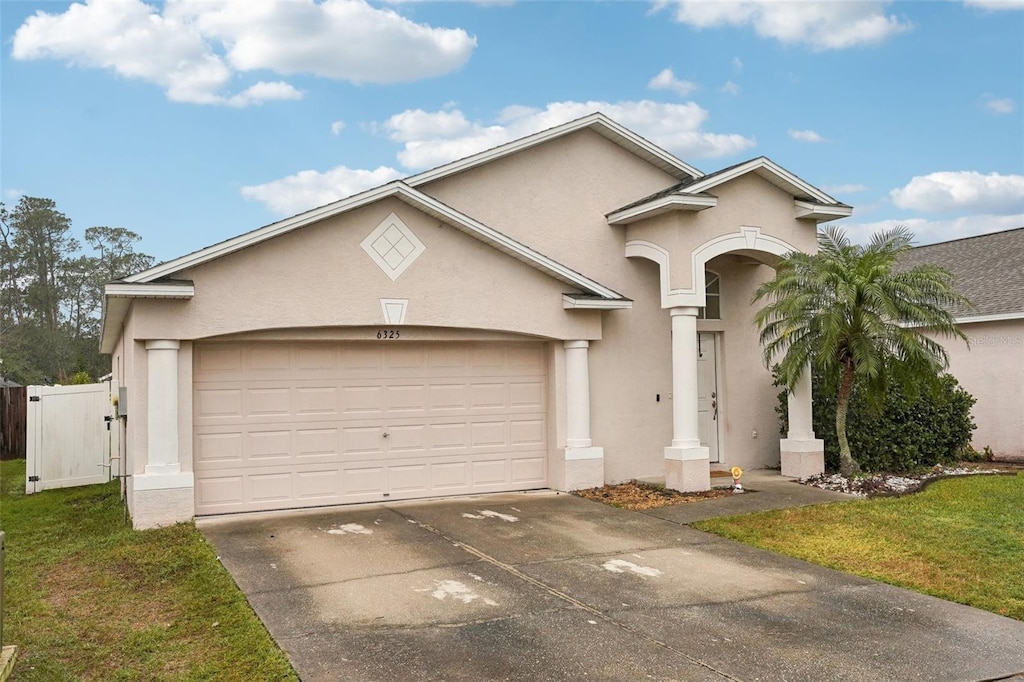 view of front of house with a garage and a front lawn