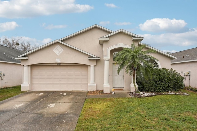 view of front of home featuring a garage and a front lawn