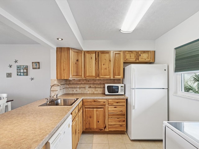 kitchen with sink, white appliances, backsplash, a textured ceiling, and light tile patterned flooring