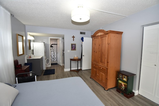 bedroom featuring hardwood / wood-style floors and a textured ceiling