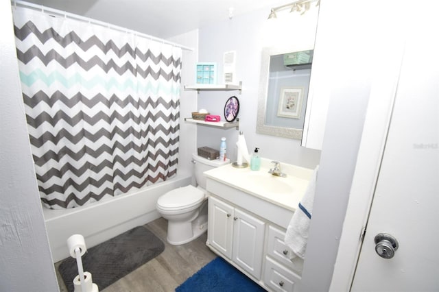 full bathroom featuring wood-type flooring, toilet, vanity, and shower / tub combo