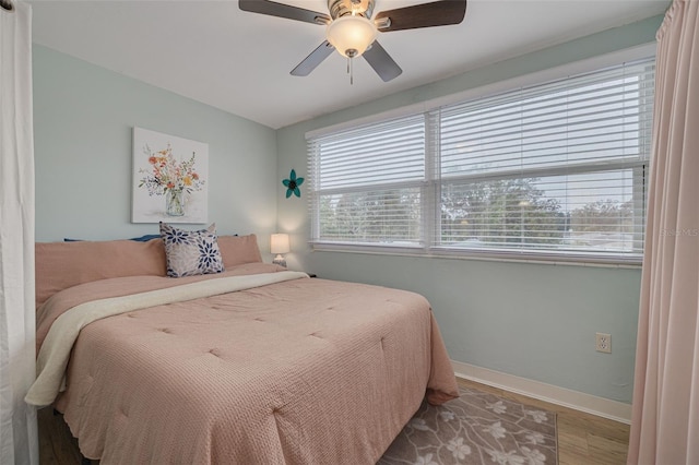 bedroom featuring wood-type flooring and ceiling fan