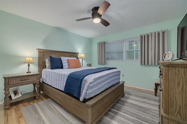 bedroom with ceiling fan and light hardwood / wood-style flooring