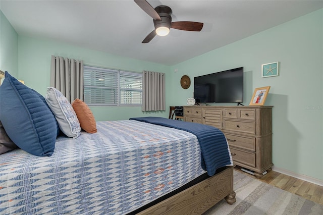 bedroom with ceiling fan and light wood-type flooring