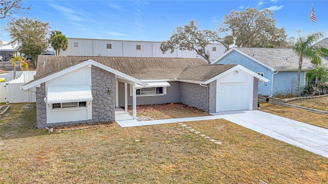 view of front of property with a garage and a front lawn