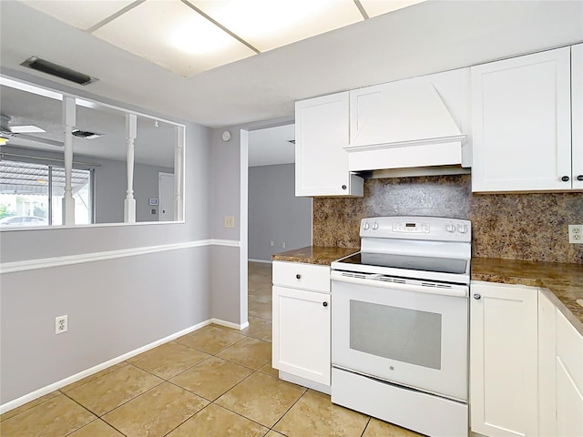 kitchen featuring premium range hood, white cabinetry, light tile patterned floors, white range with electric cooktop, and decorative backsplash