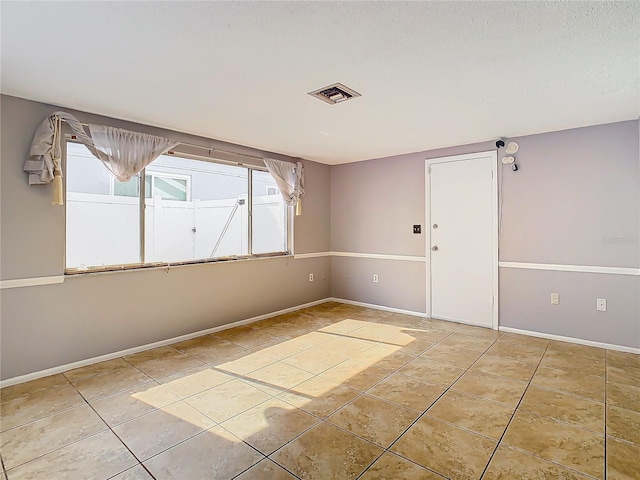 unfurnished room featuring light tile patterned flooring