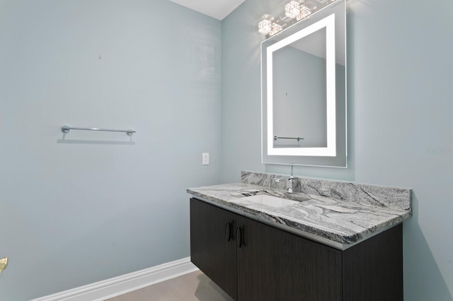 bathroom with vanity and baseboards