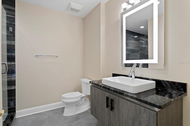 full bath featuring a stall shower, toilet, vanity, and baseboards