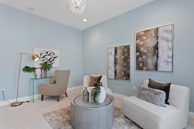 sitting room featuring recessed lighting, an inviting chandelier, baseboards, and carpet