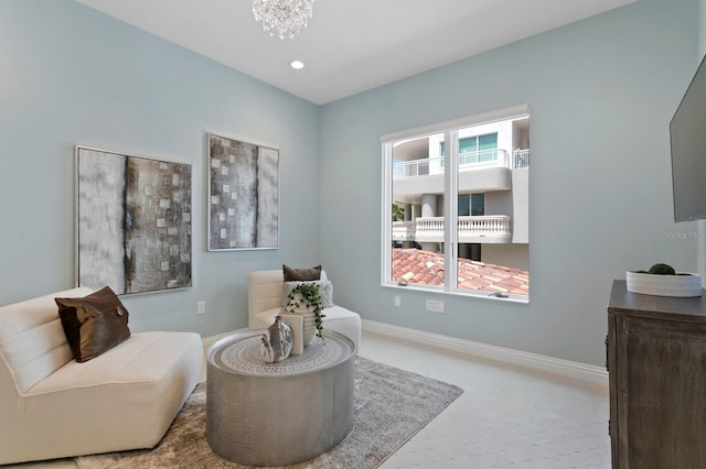 sitting room featuring recessed lighting, baseboards, and an inviting chandelier