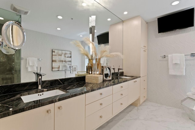 full bathroom with double vanity, recessed lighting, marble finish floor, and a sink