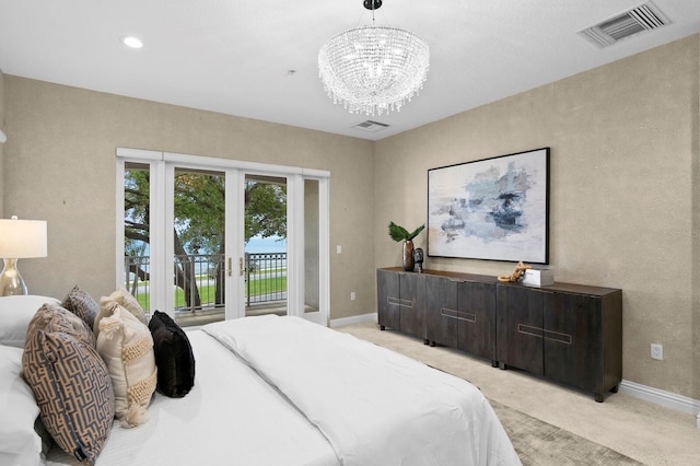 carpeted bedroom with french doors, access to exterior, and a notable chandelier