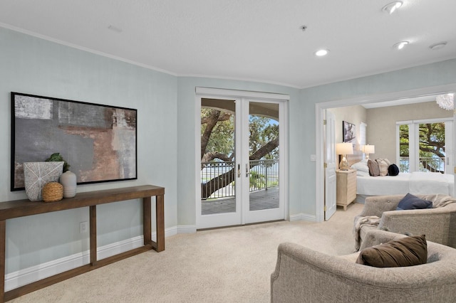 living room with ornamental molding, light colored carpet, and french doors