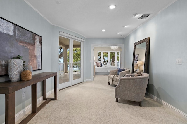 living area featuring ornamental molding, light carpet, and french doors