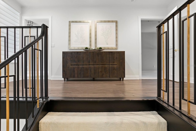 stairway featuring wood finished floors and baseboards