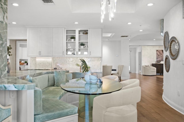 dining room with recessed lighting, visible vents, baseboards, and wood finished floors