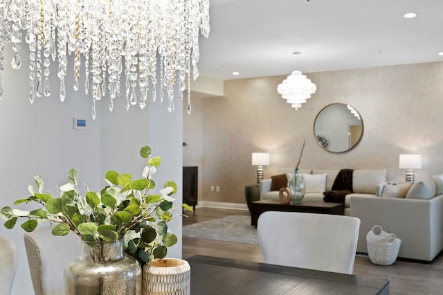 living area with recessed lighting, wood finished floors, baseboards, and a chandelier