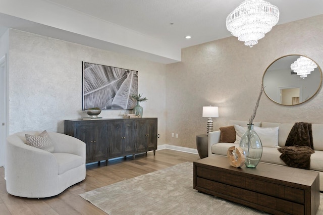 living room with recessed lighting, baseboards, wood finished floors, and a chandelier