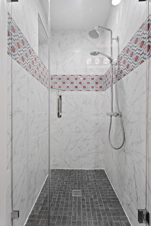 bathroom featuring a shower with door