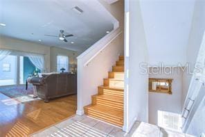 stairway featuring tile patterned flooring