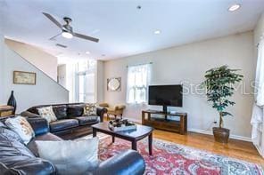 living room featuring ceiling fan and wood-type flooring